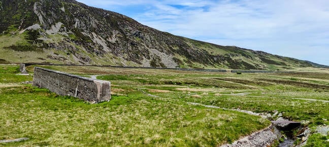 Essentially a giant L-shaped wall blocking the mouth of Cwm Eigiau the final quarter of the dam (at extreme right here) was a simple earth embankment