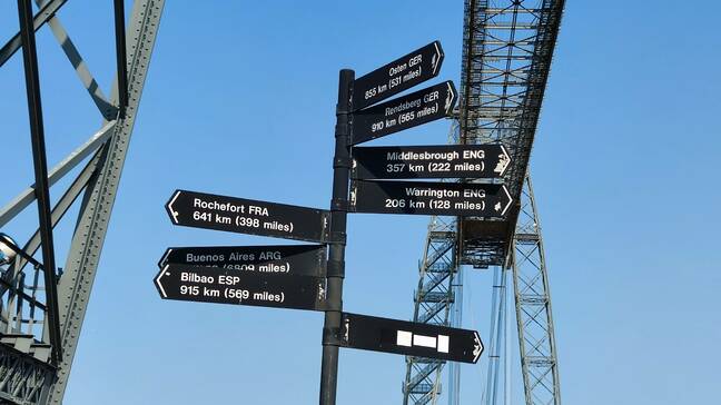 A signpost points the way to the other existing transporter bridges