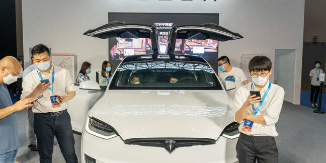 Tesla model X displayed in China auto expo during covid19 pandemic. Staff wear mask