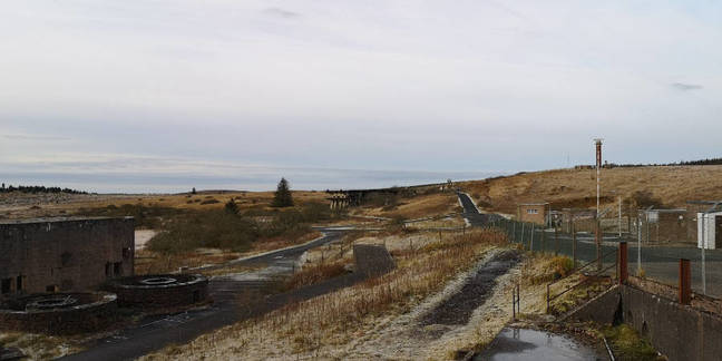 The western test stand as seen from the eastern at Greymare. Note the distance and the LOX storage tank bases at left and the public address tower to the right